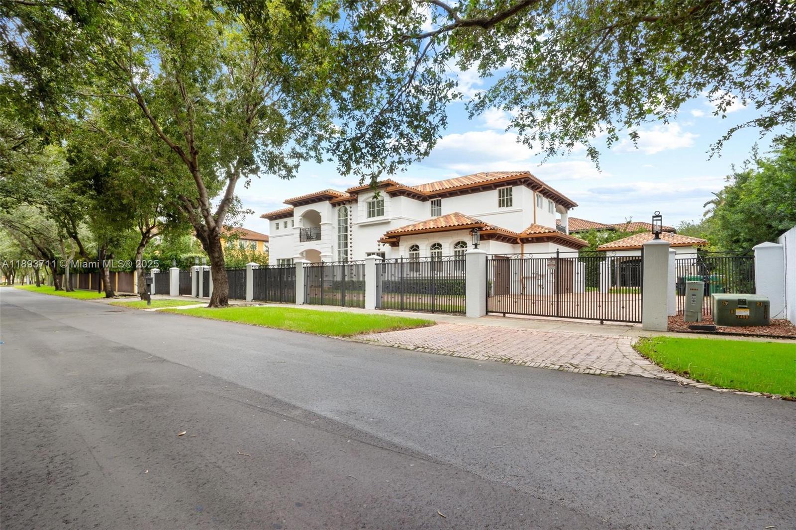 16763 Northwest 77th Path Miami Lakes, FL 33016 - Photo 3 of 53 a front view of house with yard and green space