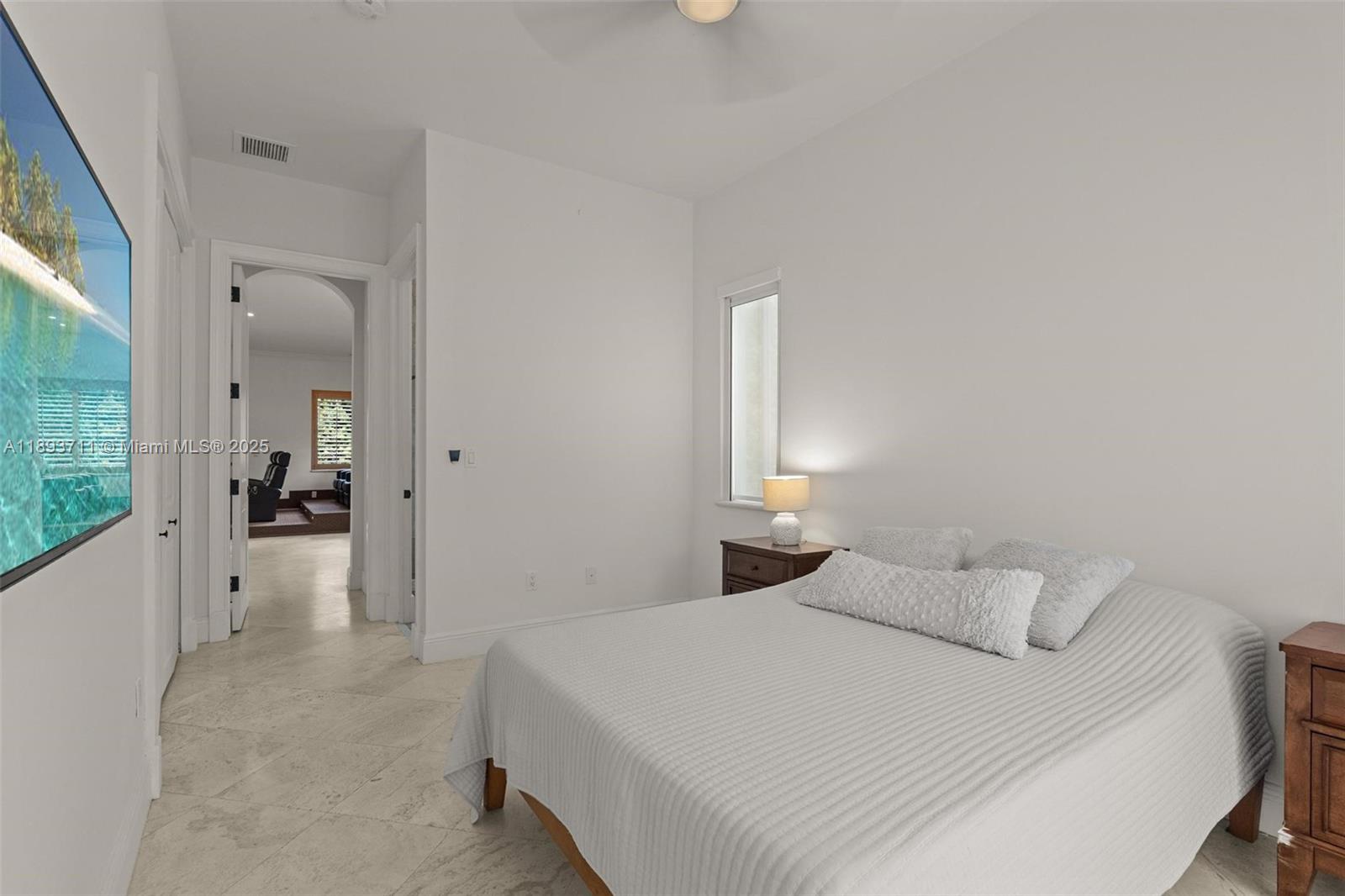 16763 Northwest 77th Path Miami Lakes, FL 33016 - Photo 31 of 53 a bedroom with a bed and a large window