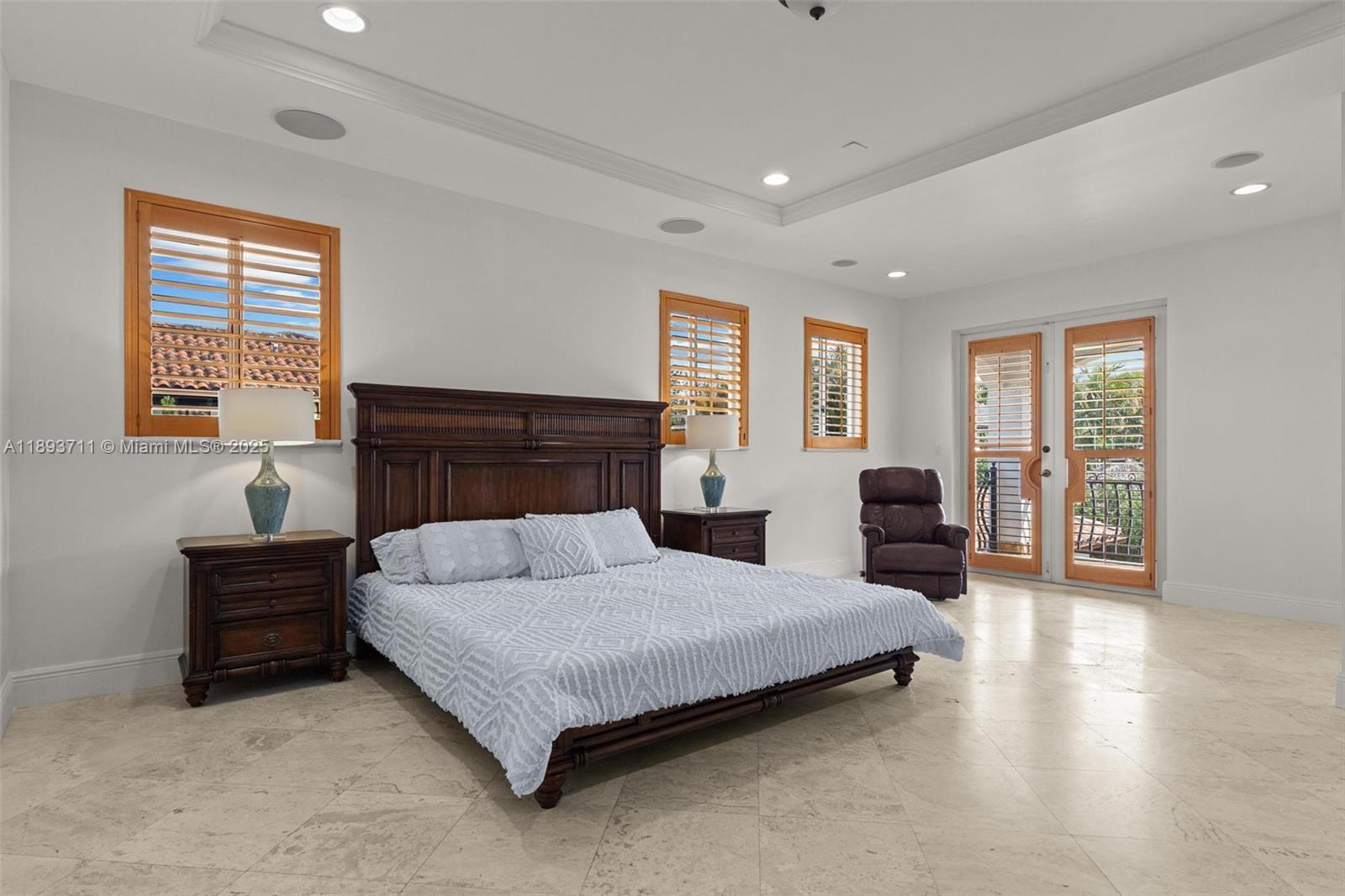 16763 Northwest 77th Path Miami Lakes, FL 33016 - Photo 34 of 53 a bedroom with a large bed and wooden floor