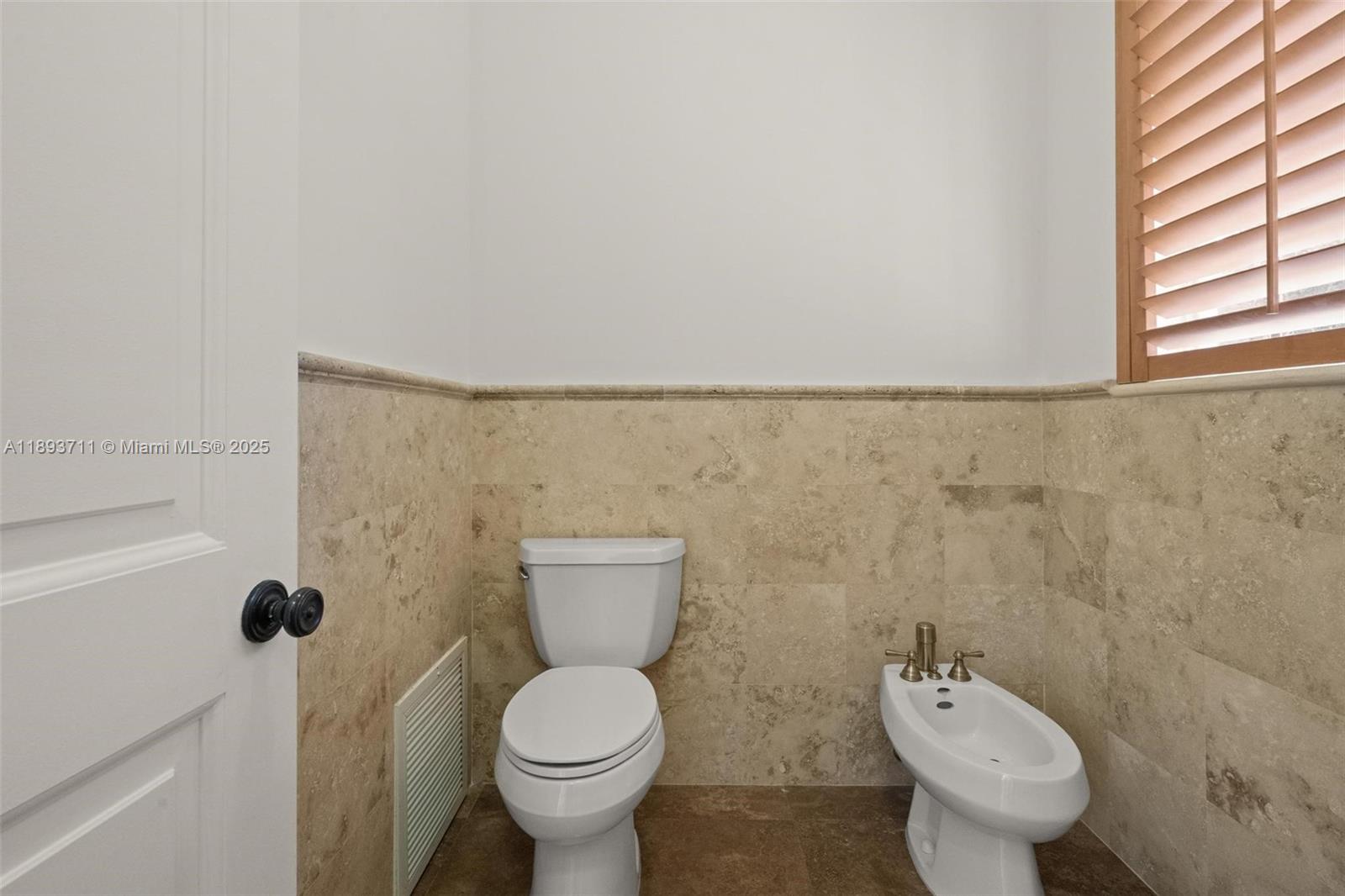 16763 Northwest 77th Path Miami Lakes, FL 33016 - Photo 39 of 53 a bathroom with a toilet and a shower curtain