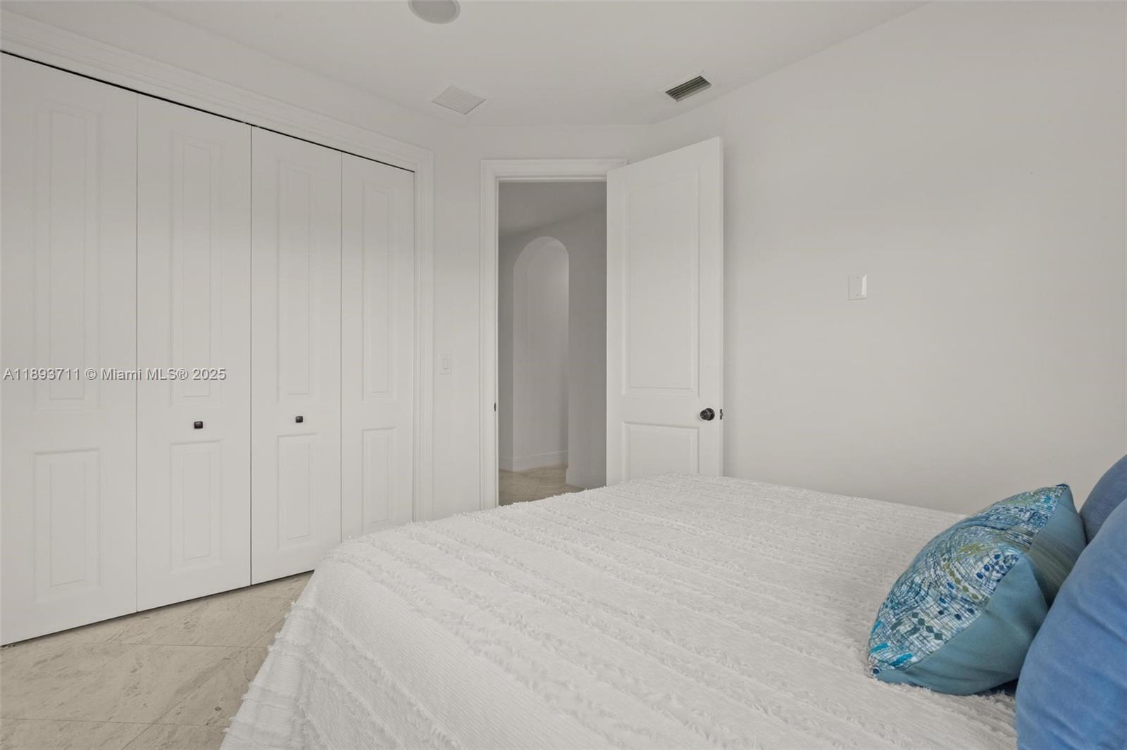 16763 Northwest 77th Path Miami Lakes, FL 33016 - Photo 43 of 53 a bedroom with a bed and a painting on the wall