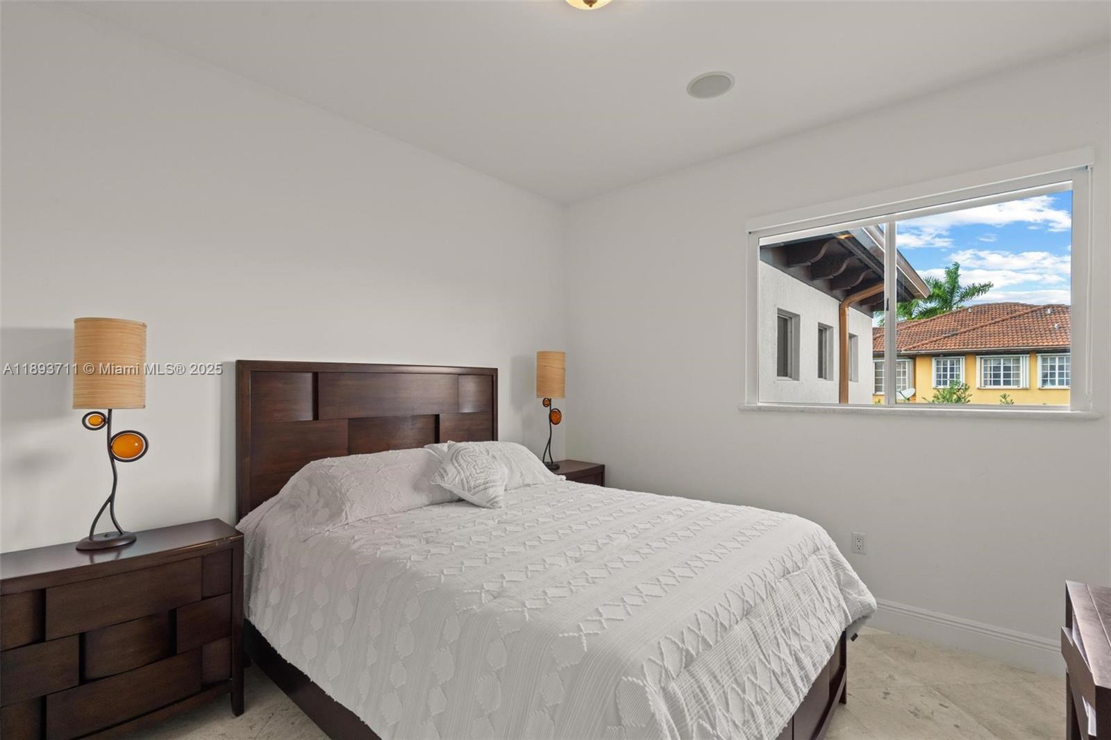 16763 Northwest 77th Path Miami Lakes, FL 33016 - Photo 44 of 53 a bedroom with a bed and window