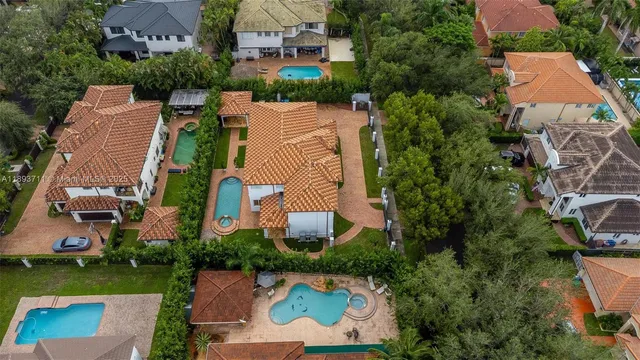 a view of a yard with flower plants and wooden fence
