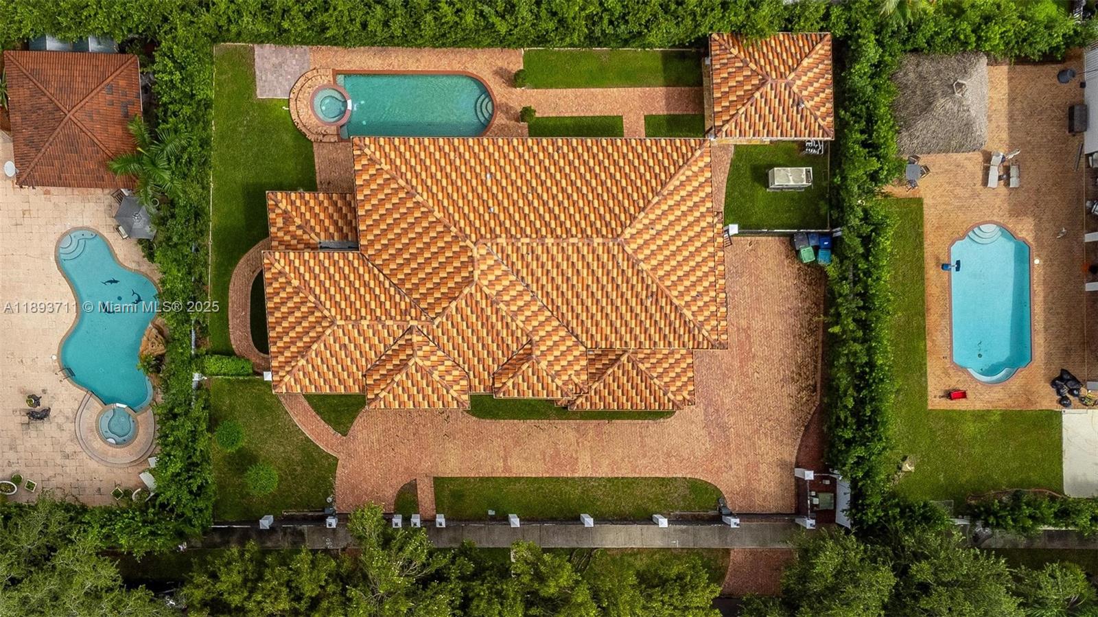 16763 Northwest 77th Path Miami Lakes, FL 33016 - Photo 49 of 53 an aerial view of a house with a garden and trees