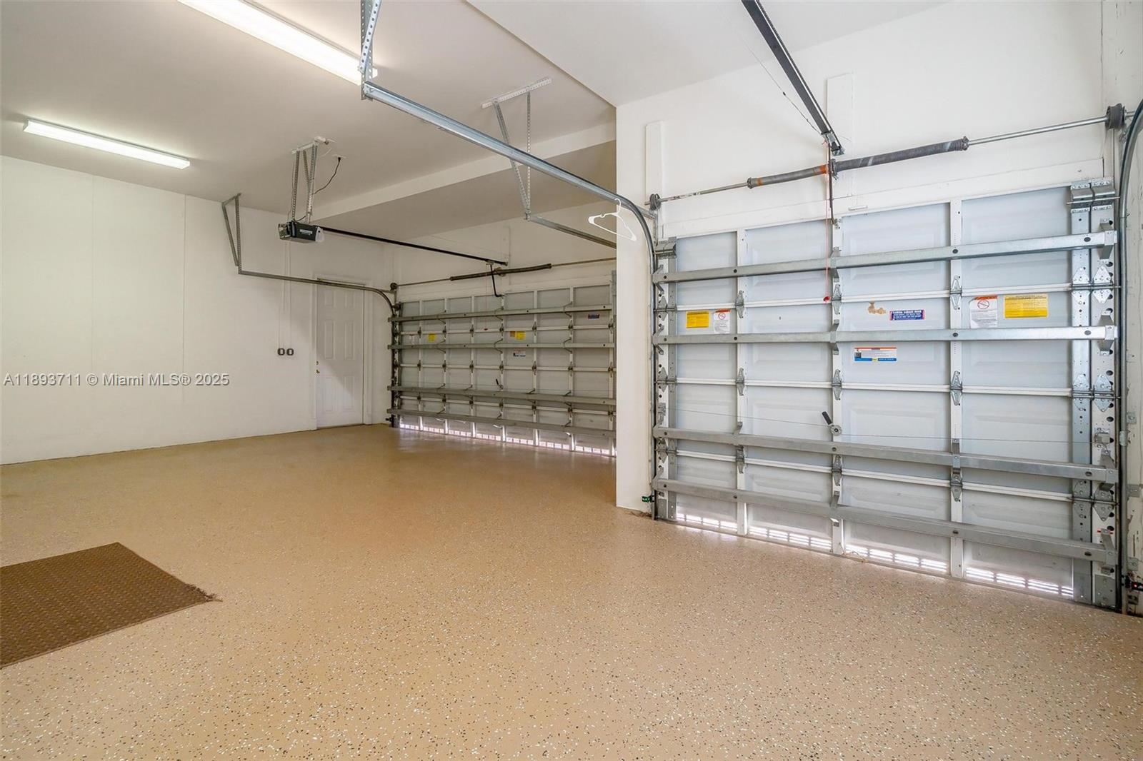 16763 Northwest 77th Path Miami Lakes, FL 33016 - Photo 7 of 53 a view of a room with racks on the wall