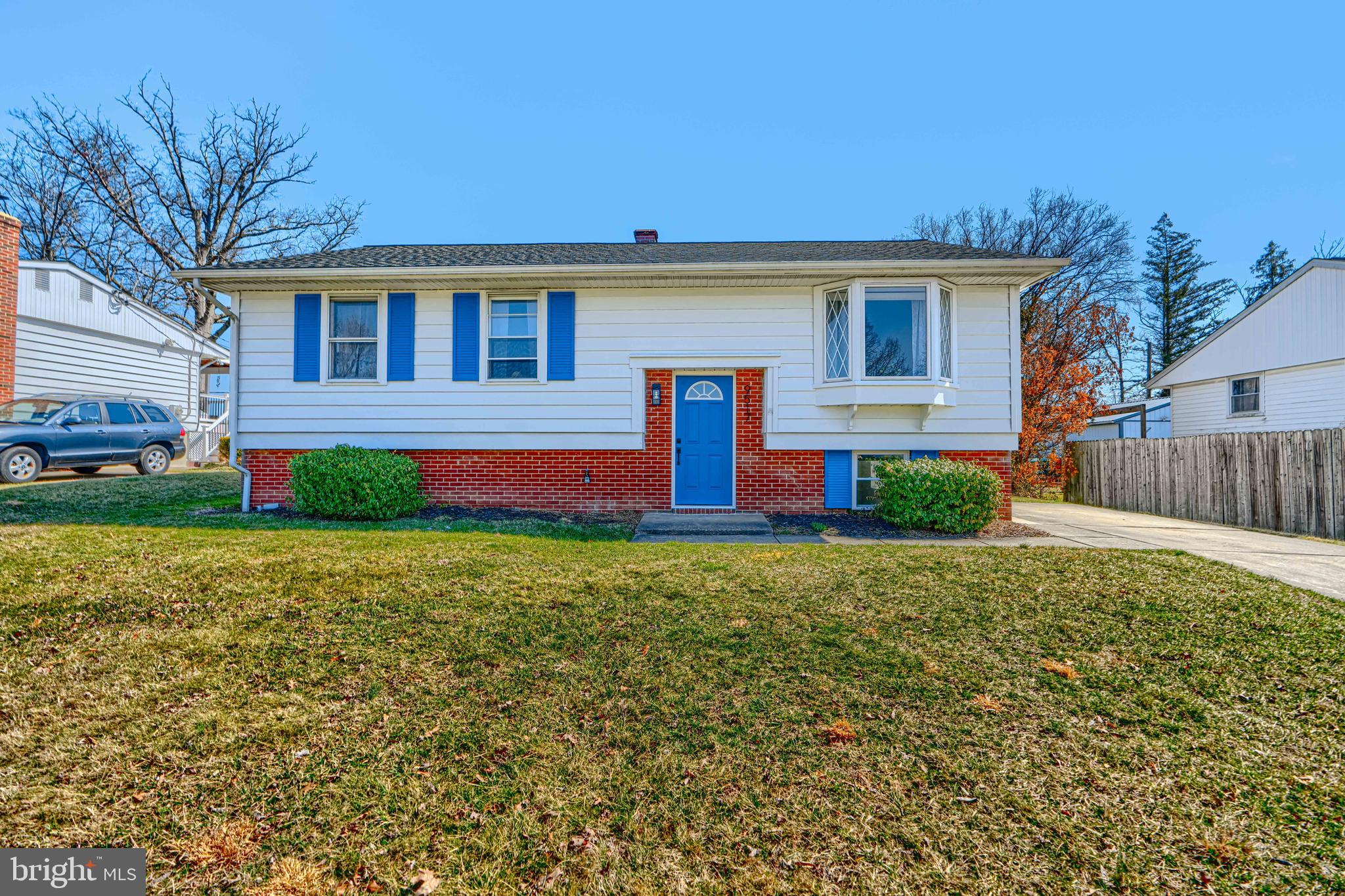 a front view of house with yard and green space