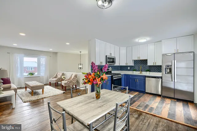 a view of a dining room with furniture wooden floor and a chandelier