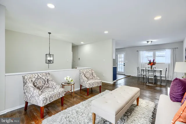 a kitchen with stainless steel appliances granite countertop a refrigerator a stove a sink dishwasher with a dining table and chairs