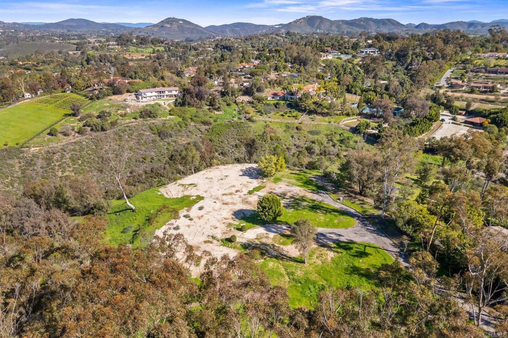 18065 Avenida Alondra Rancho Santa Fe, CA 92067 - Photo 2 of 15 a view of a lush green field with mountains in the background