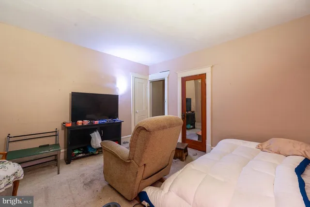 a bedroom with bed and a flat screen tv