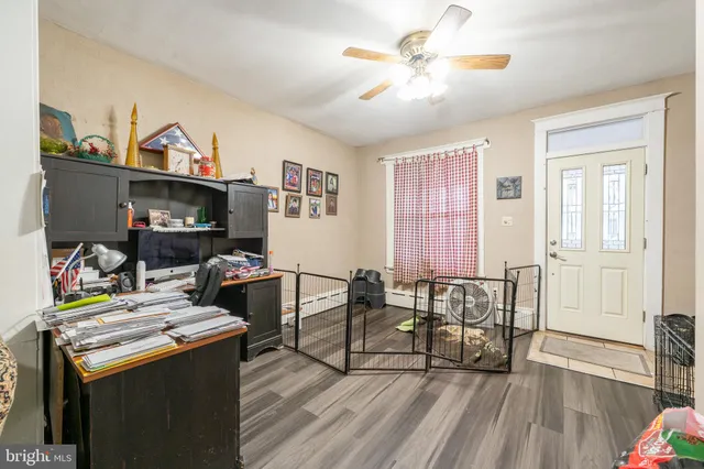 a view of a workspace with furniture and a window