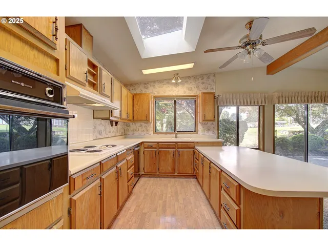 a kitchen with stainless steel appliances granite countertop a sink and cabinets