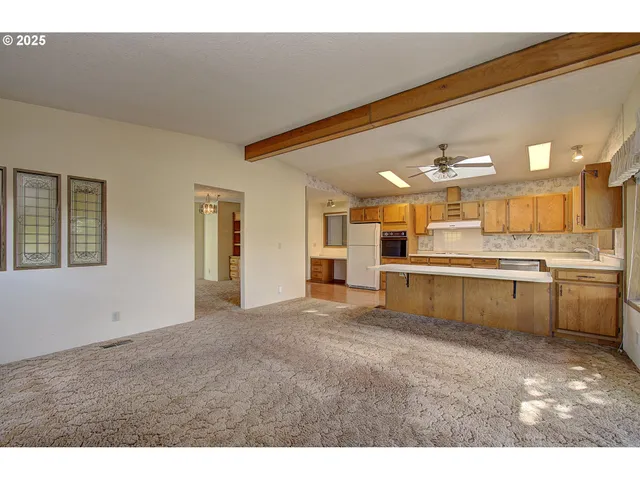 a large white kitchen with a sink and cabinets