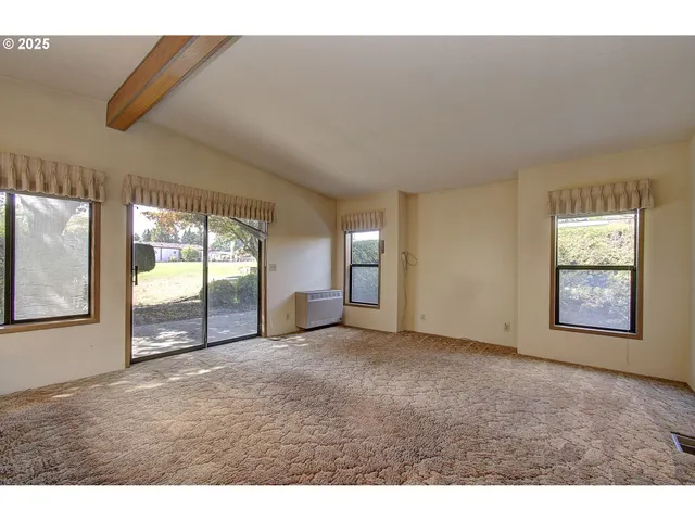 a view of a big room with windows and brick walls