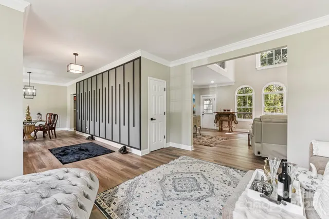 a bedroom with a bed and a view of living room