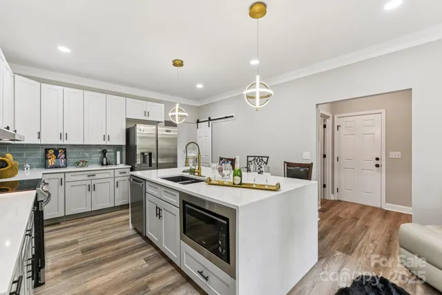 a kitchen with a stove a sink and a refrigerator