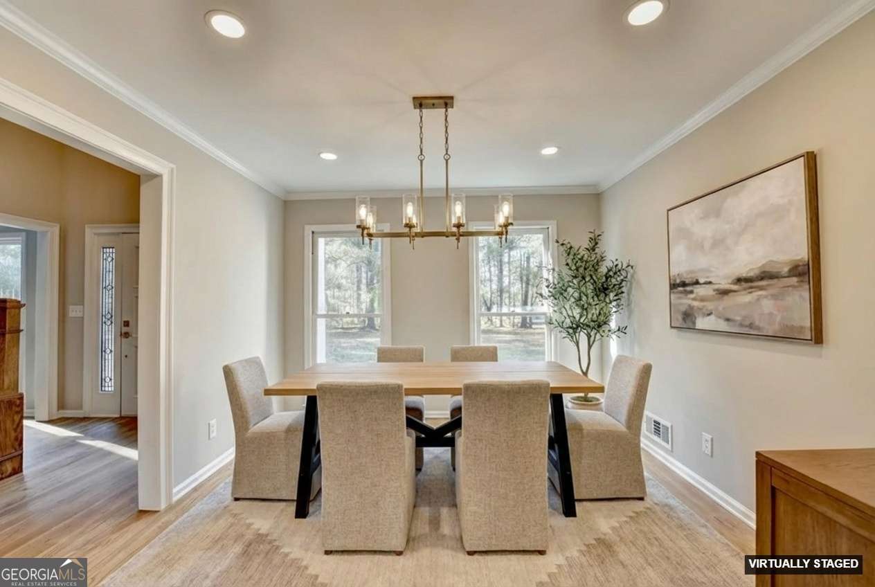 590 Manning Gin Road Monroe, GA 30656 - Photo 11 of 76 a view of a dining room with furniture window and wooden floor