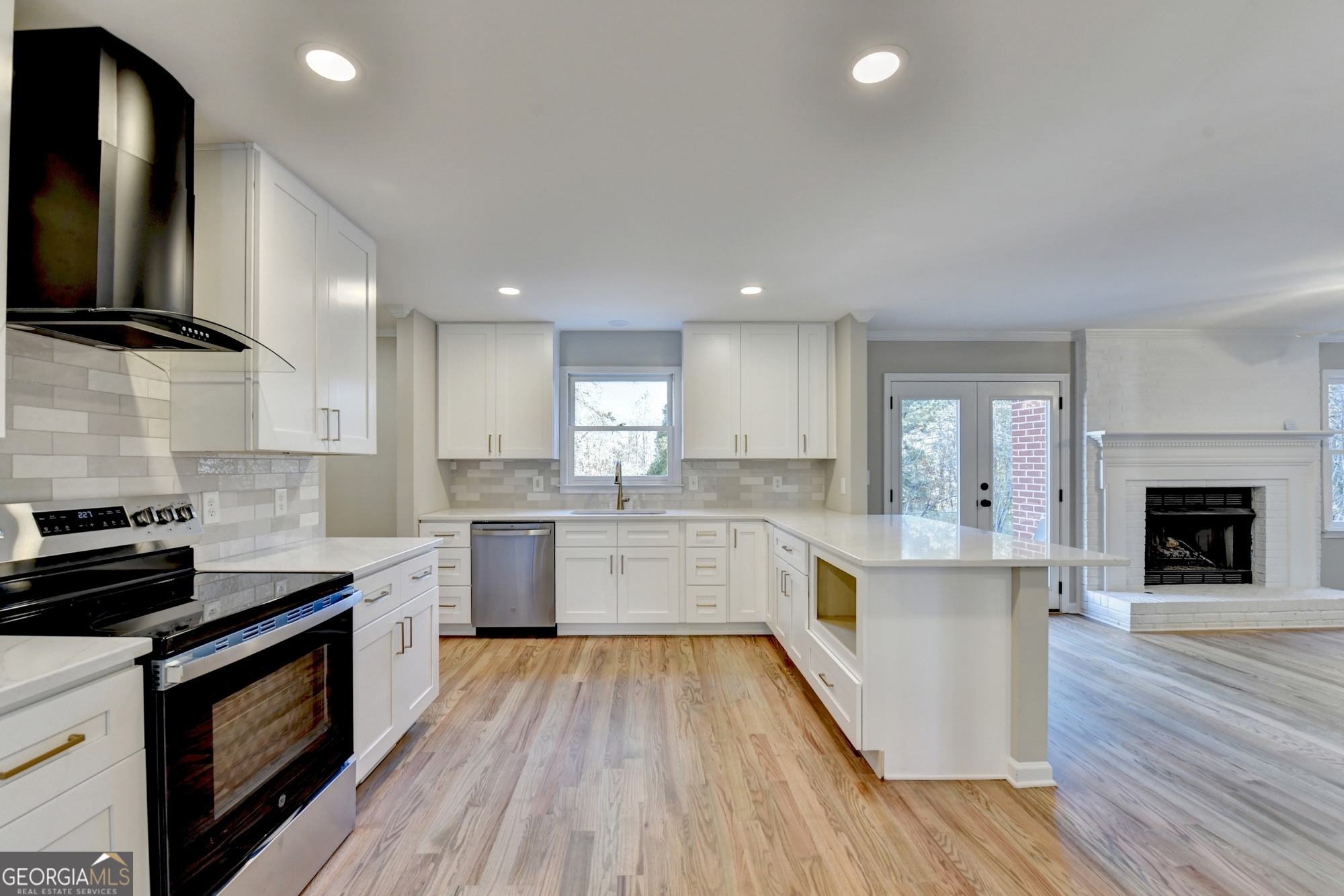 590 Manning Gin Road Monroe, GA 30656 - Photo 14 of 76 a large kitchen with a lot of counter space and wooden floor