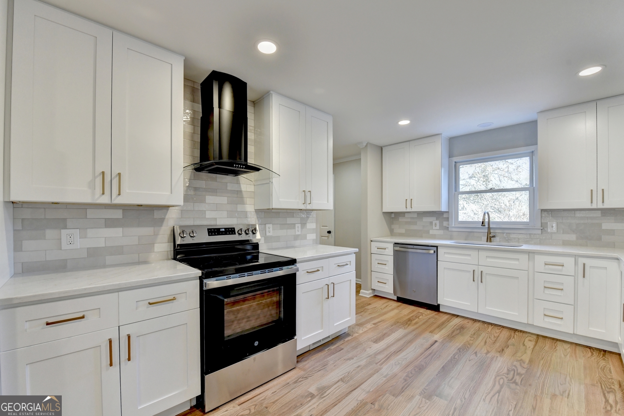 590 Manning Gin Road Monroe, GA 30656 - Photo 15 of 76 a kitchen with granite countertop cabinets stainless steel appliances and wooden floor