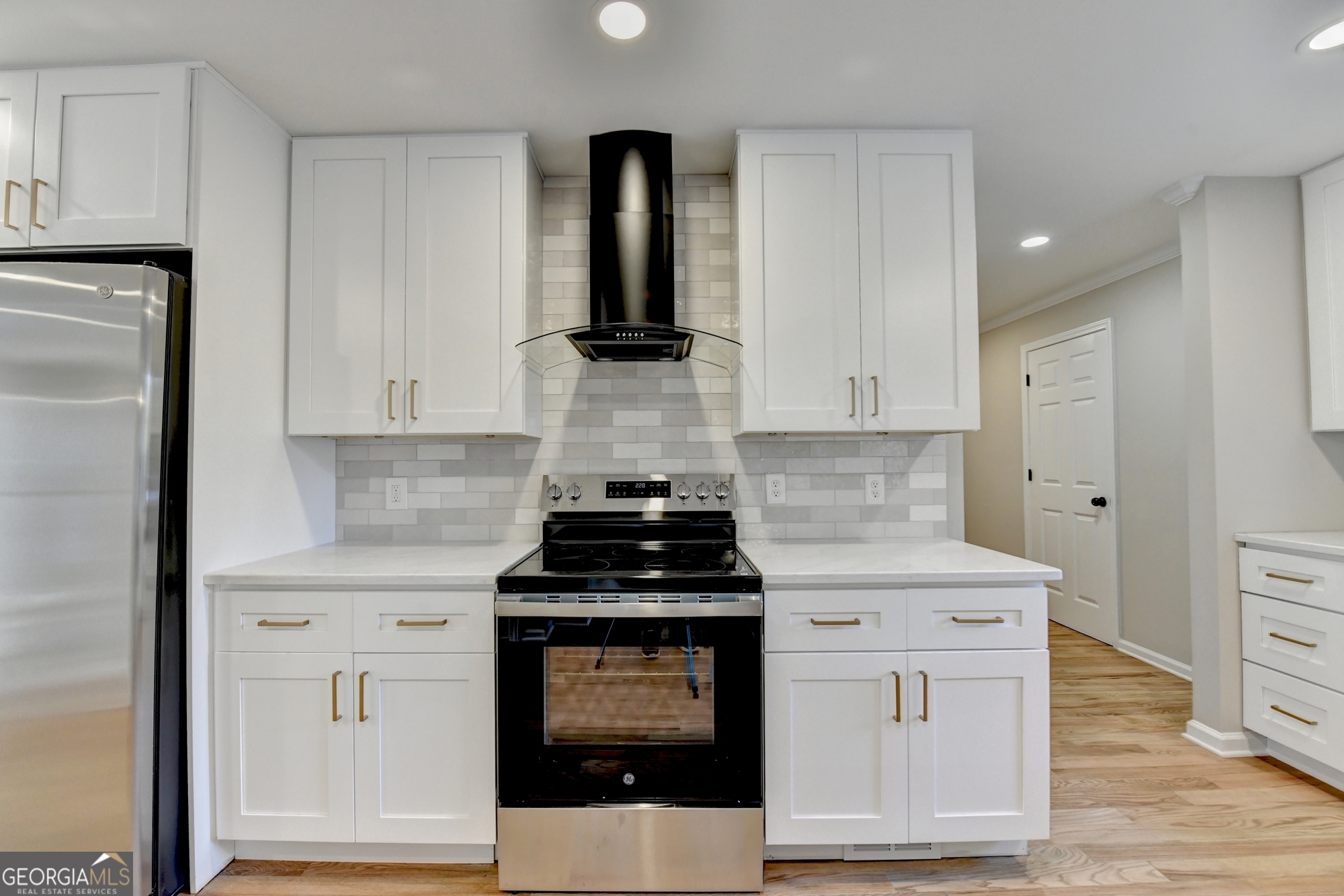 590 Manning Gin Road Monroe, GA 30656 - Photo 16 of 76 a kitchen with white cabinets and appliances