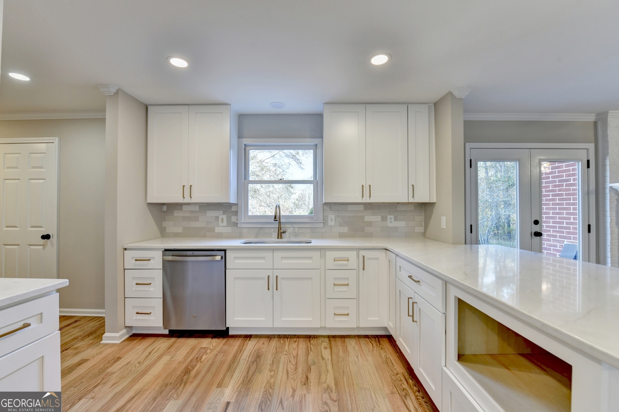 590 Manning Gin Road Monroe, GA 30656 - Photo 17 of 76 a large kitchen with cabinets wooden floor and stainless steel appliances