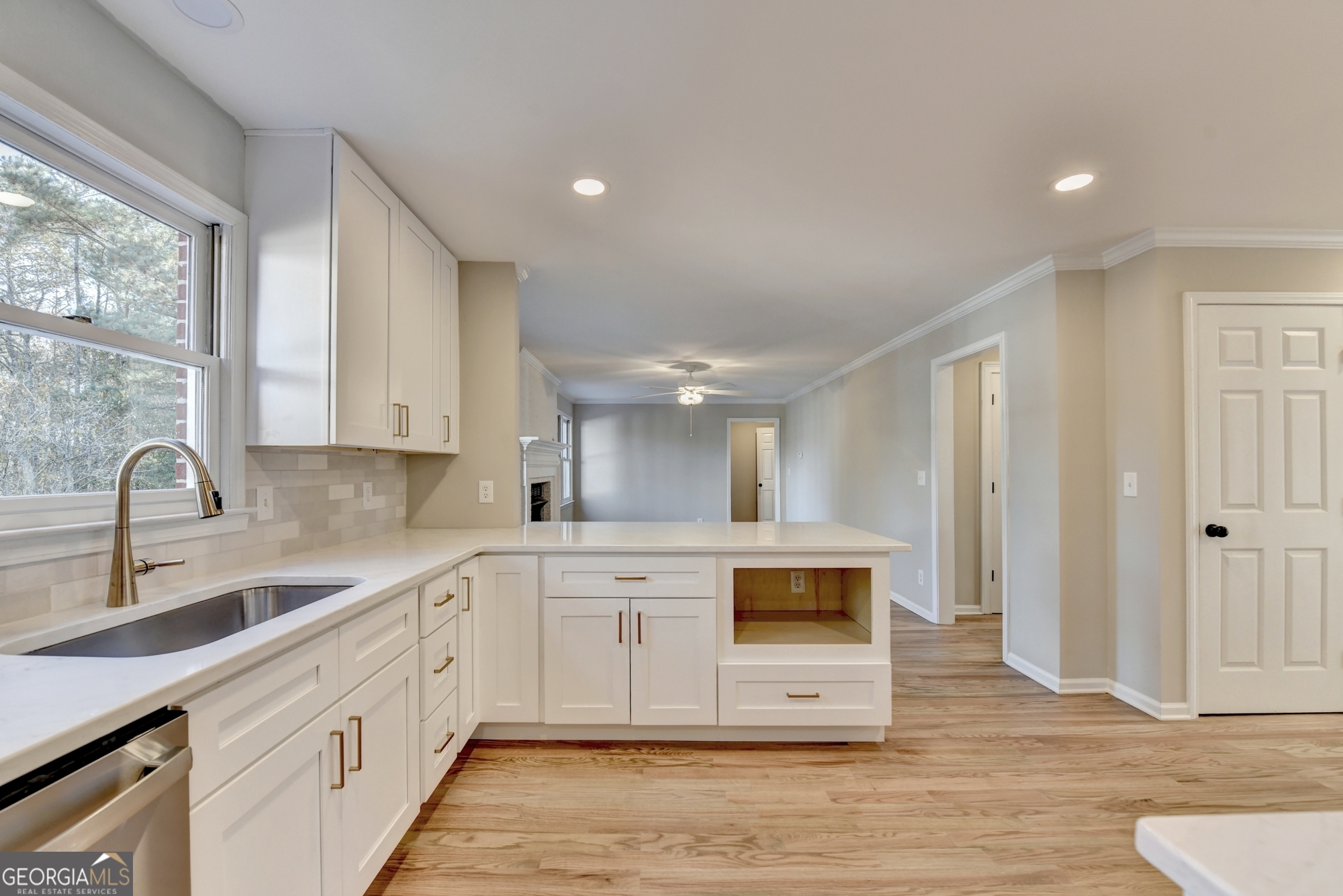 590 Manning Gin Road Monroe, GA 30656 - Photo 19 of 76 a kitchen with stainless steel appliances white cabinets a sink and a stove