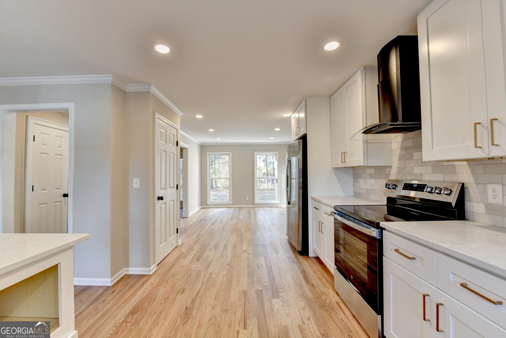 590 Manning Gin Road Monroe, GA 30656 - Photo 20 of 76 a kitchen with stainless steel appliances granite countertop wooden cabinets a stove top oven a sink and dishwasher