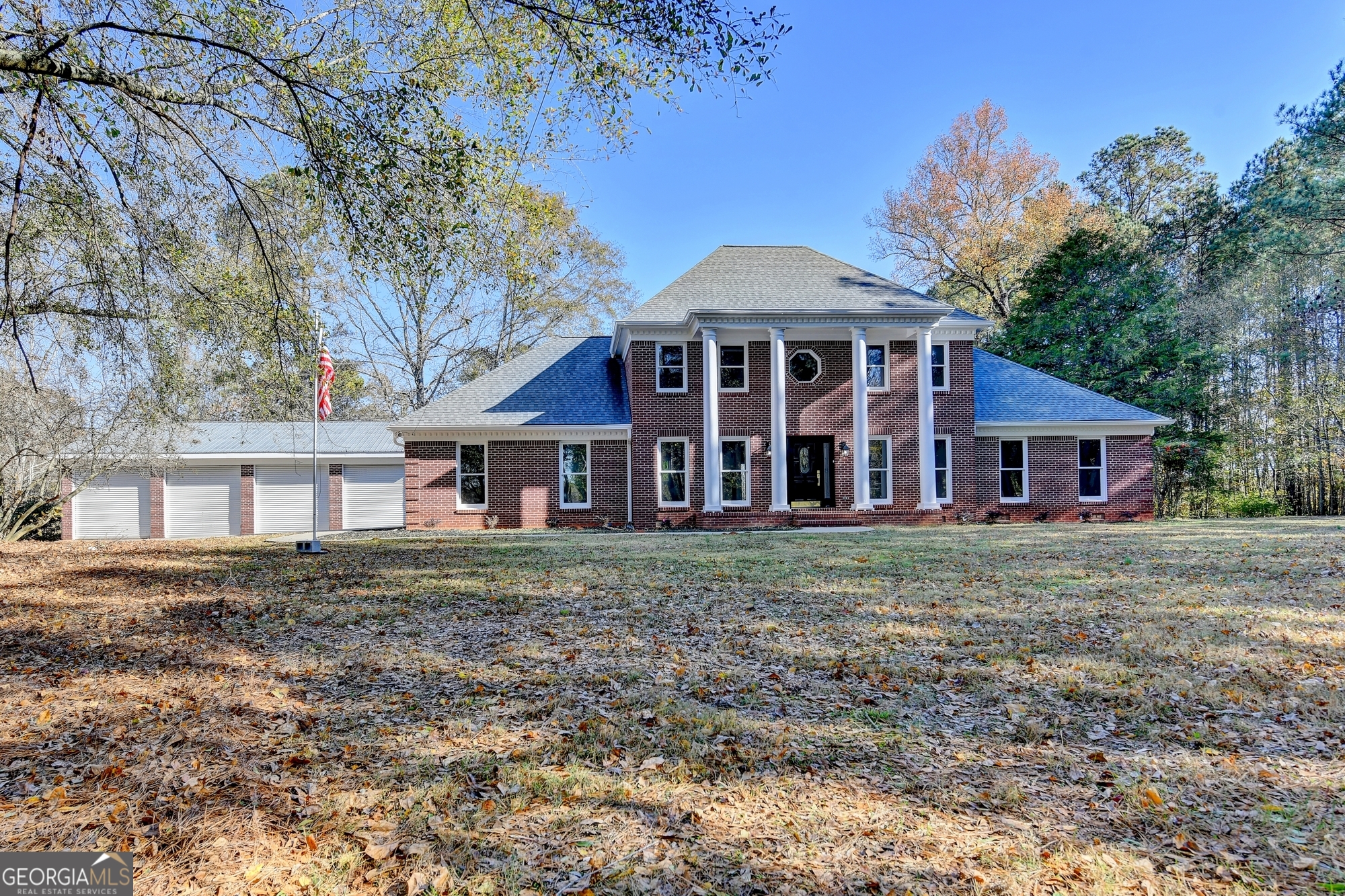 590 Manning Gin Road Monroe, GA 30656 - Photo 2 of 76 a front view of a house with a garden
