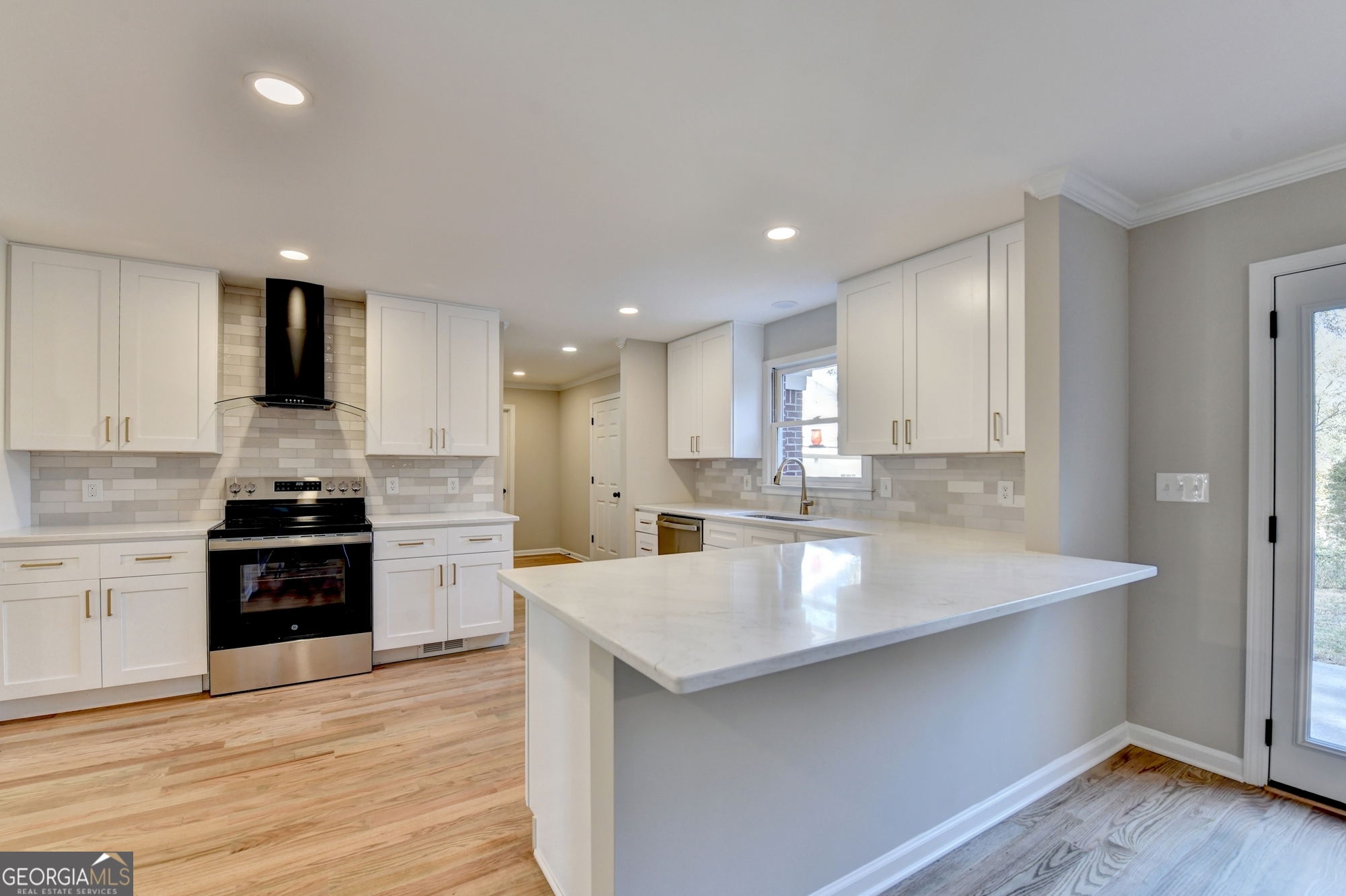 590 Manning Gin Road Monroe, GA 30656 - Photo 22 of 76 a large kitchen with stainless steel appliances granite countertop a sink dishwasher and a stove with wooden floor