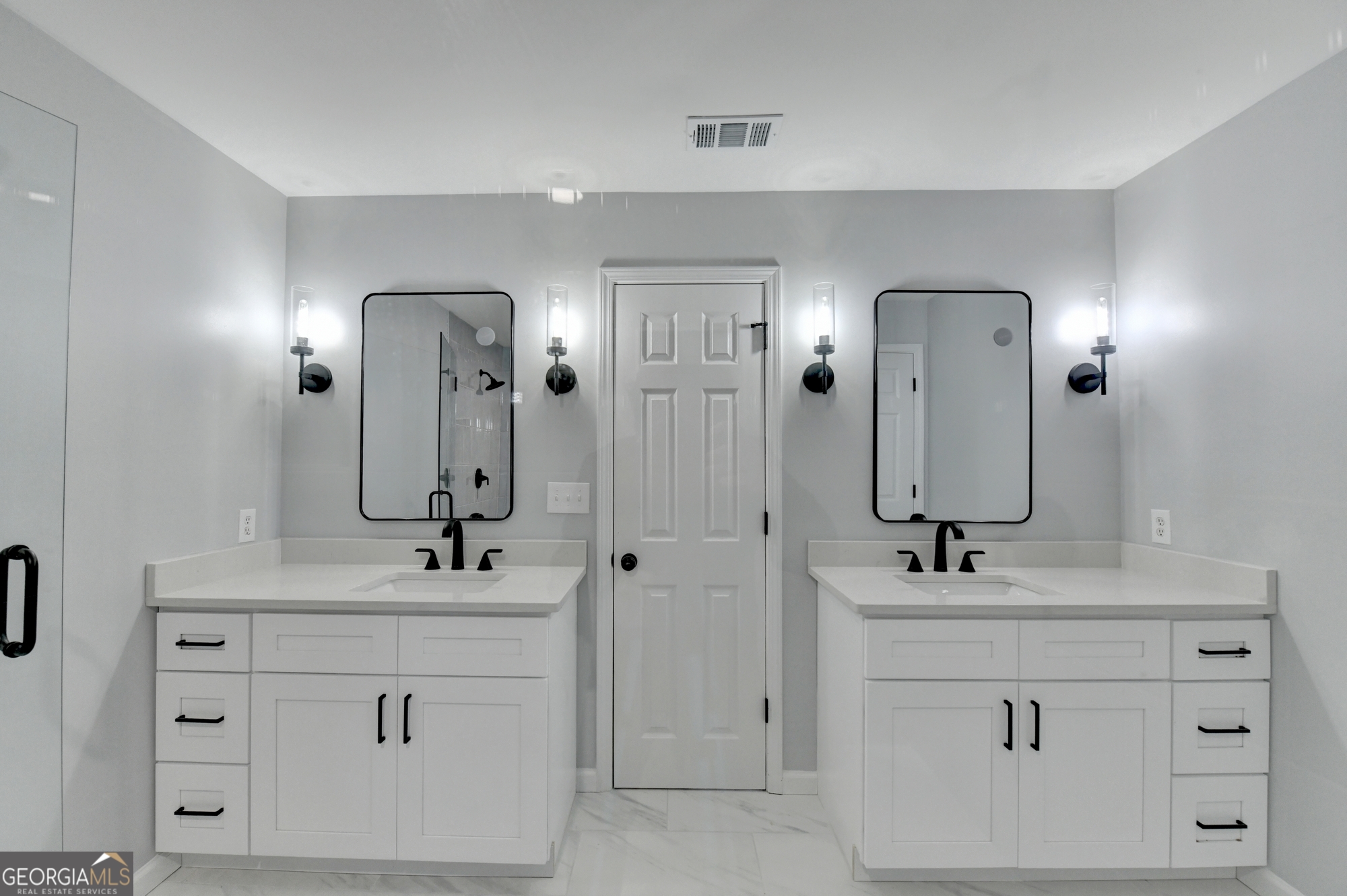 590 Manning Gin Road Monroe, GA 30656 - Photo 52 of 76 a bathroom with a double vanity sink and a mirror