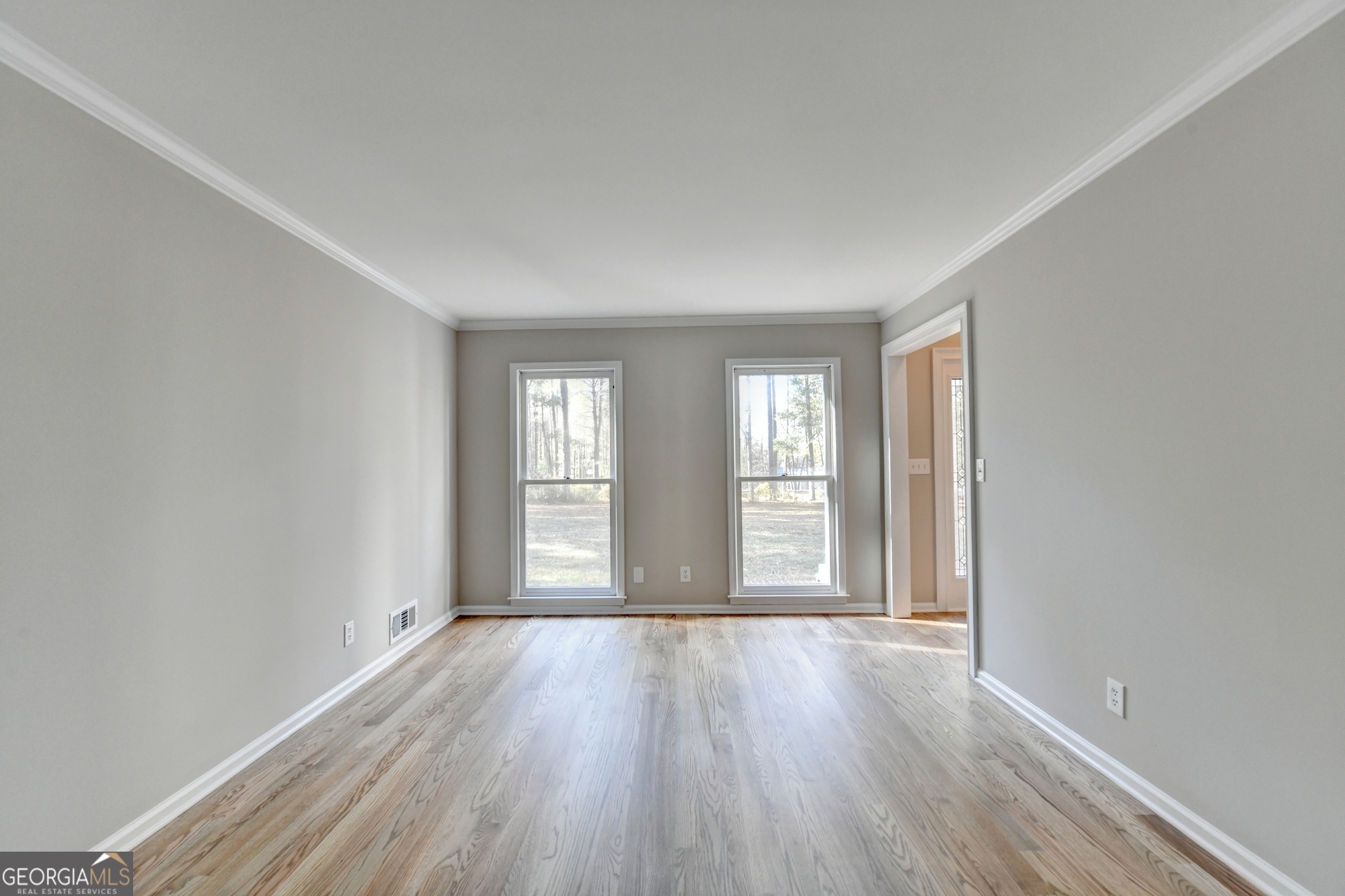590 Manning Gin Road Monroe, GA 30656 - Photo 6 of 76 an empty room with wooden floor and windows