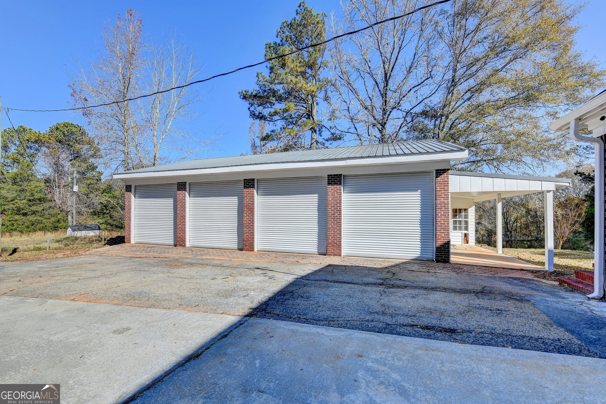 590 Manning Gin Road Monroe, GA 30656 - Photo 61 of 76 a front view of a house with a garden and trees