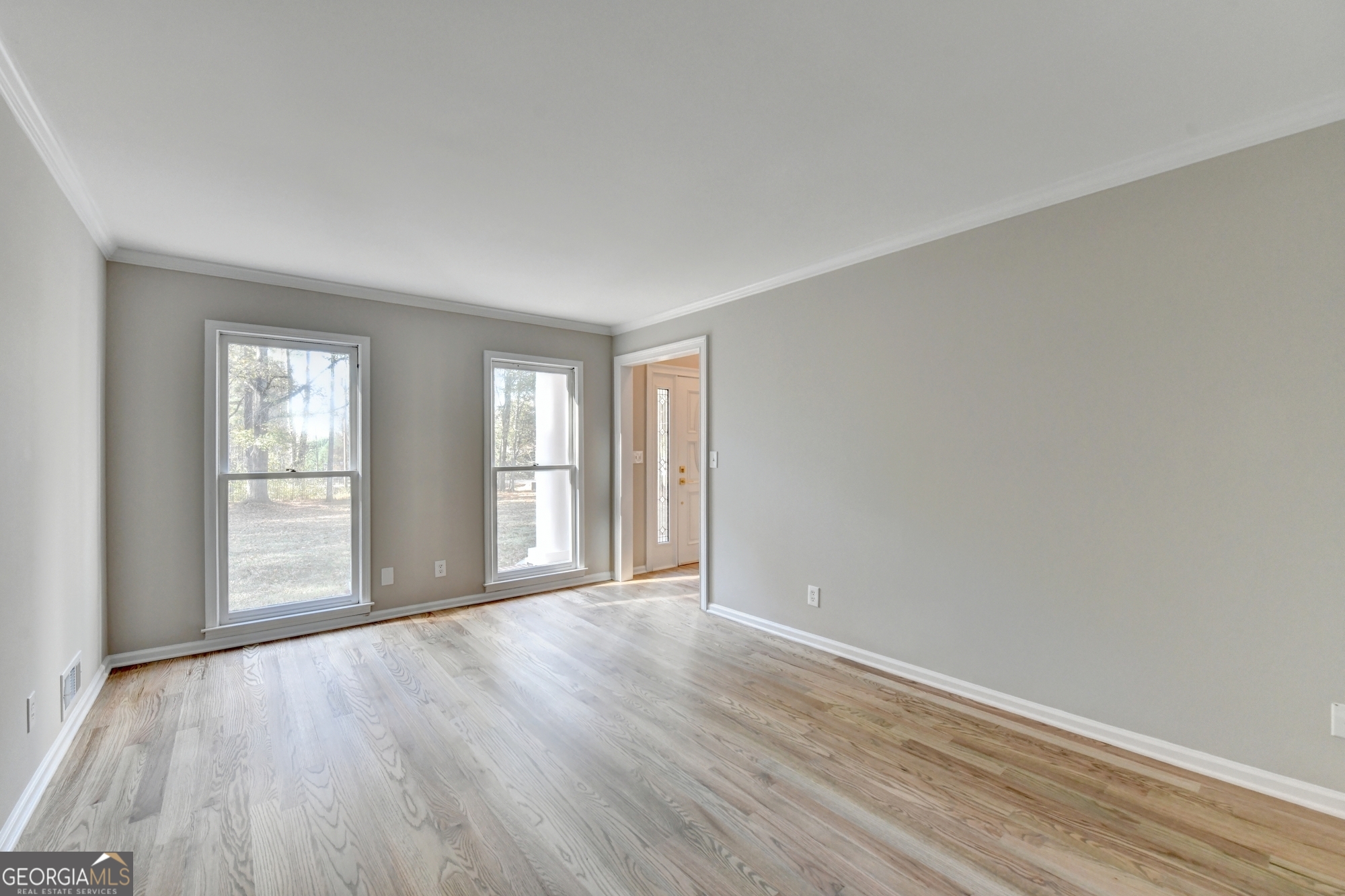 590 Manning Gin Road Monroe, GA 30656 - Photo 7 of 76 an empty room with wooden floor and windows