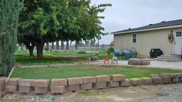 a view of a backyard with plants and a patio