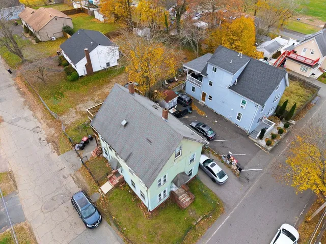 an aerial view of residential house with parking