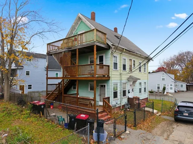 a view of a house with a chairs and table in a patio