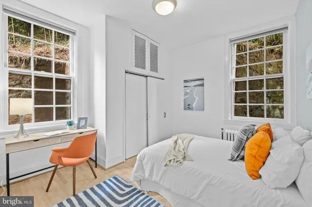 a bedroom with a bed and wooden floor