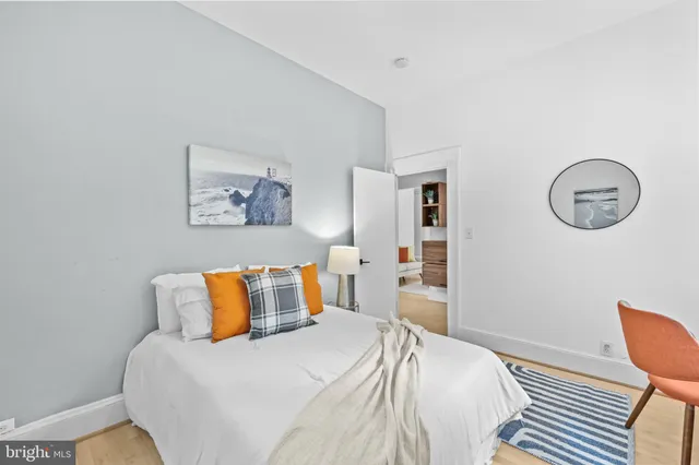 a bedroom with bed and painting on the wall