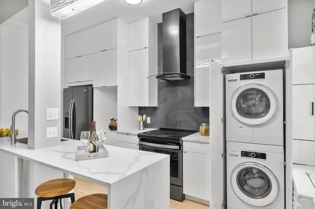 a kitchen with a sink cabinets and washing machine