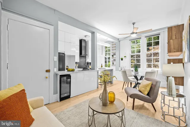 a living room with furniture and a kitchen area