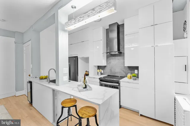 a kitchen with stainless steel appliances a sink a stove and a refrigerator