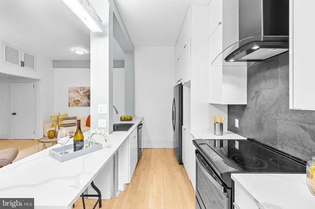 a kitchen with a sink a stove and a refrigerator
