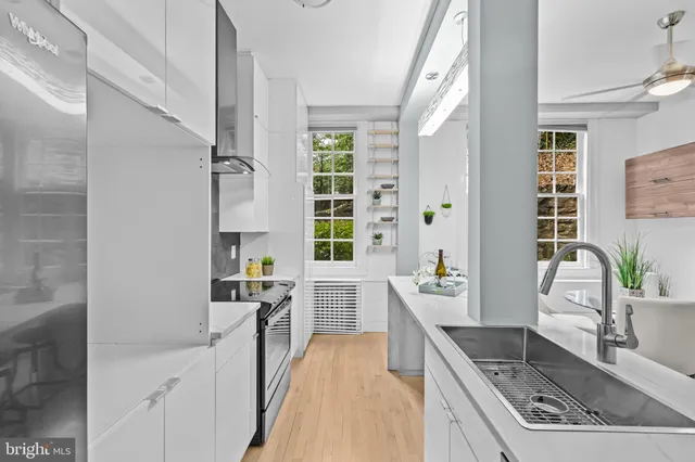 a kitchen with stainless steel appliances granite countertop a sink stove and cabinets