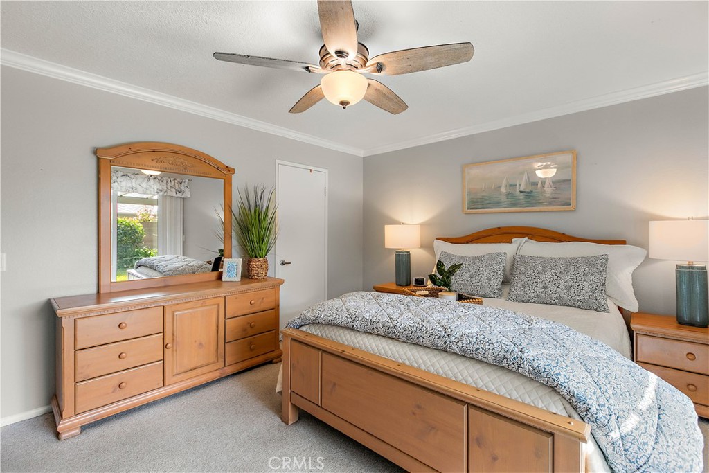 7241 Marine Avenue Rancho Cucamonga, CA 91701 - Photo 1 of 48 a bedroom with a large bed and a chandelier