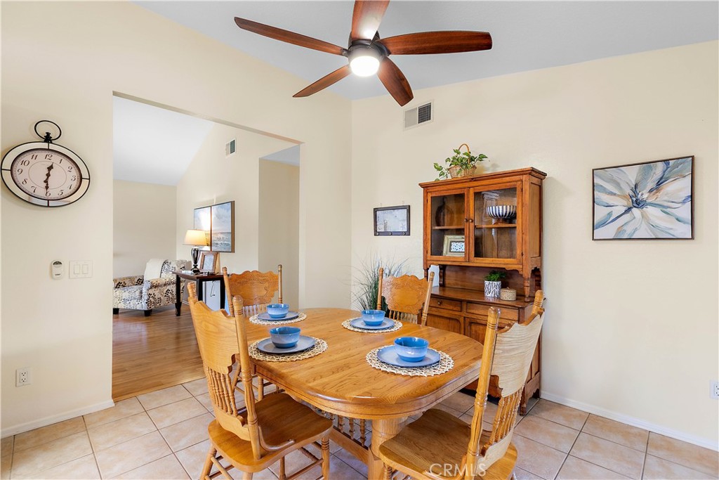 7241 Marine Avenue Rancho Cucamonga, CA 91701 - Photo 15 of 48 a view of a dining room with furniture and a chandelier fan