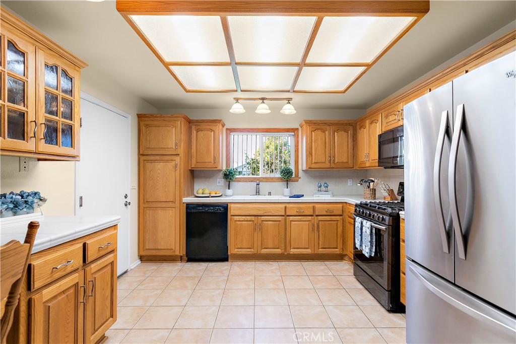 7241 Marine Avenue Rancho Cucamonga, CA 91701 - Photo 17 of 48 a kitchen with stainless steel appliances granite countertop a refrigerator and a sink