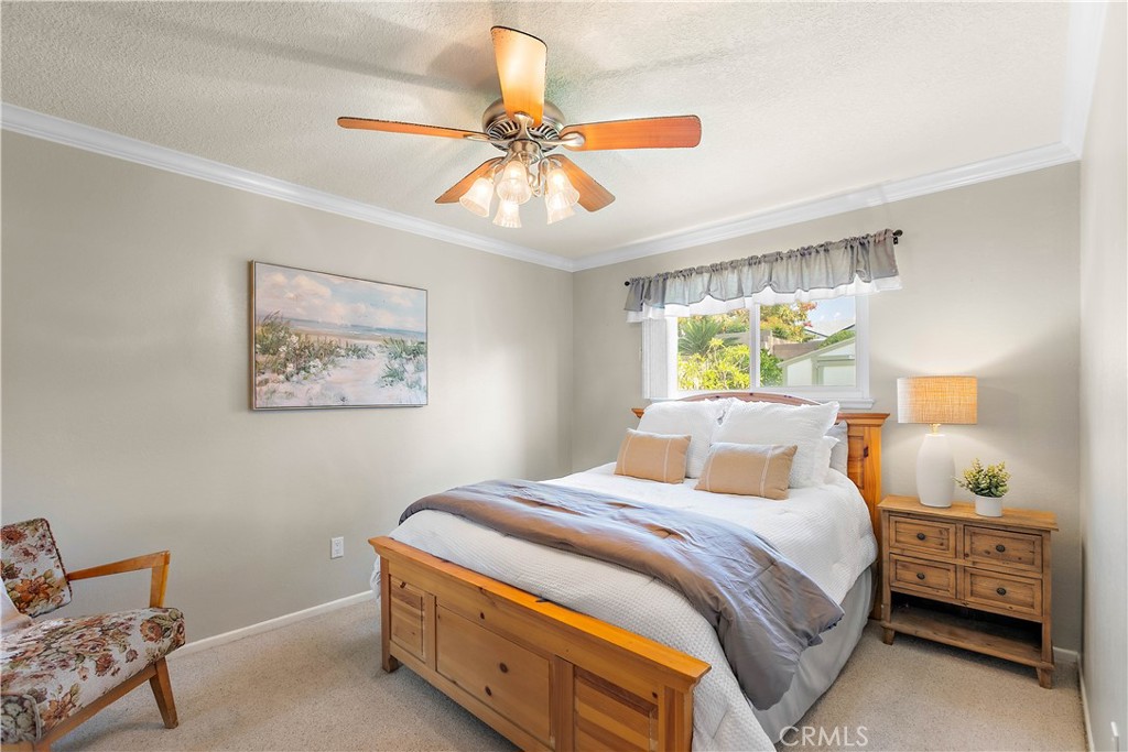 7241 Marine Avenue Rancho Cucamonga, CA 91701 - Photo 25 of 48 a bedroom with a bed and a chandelier