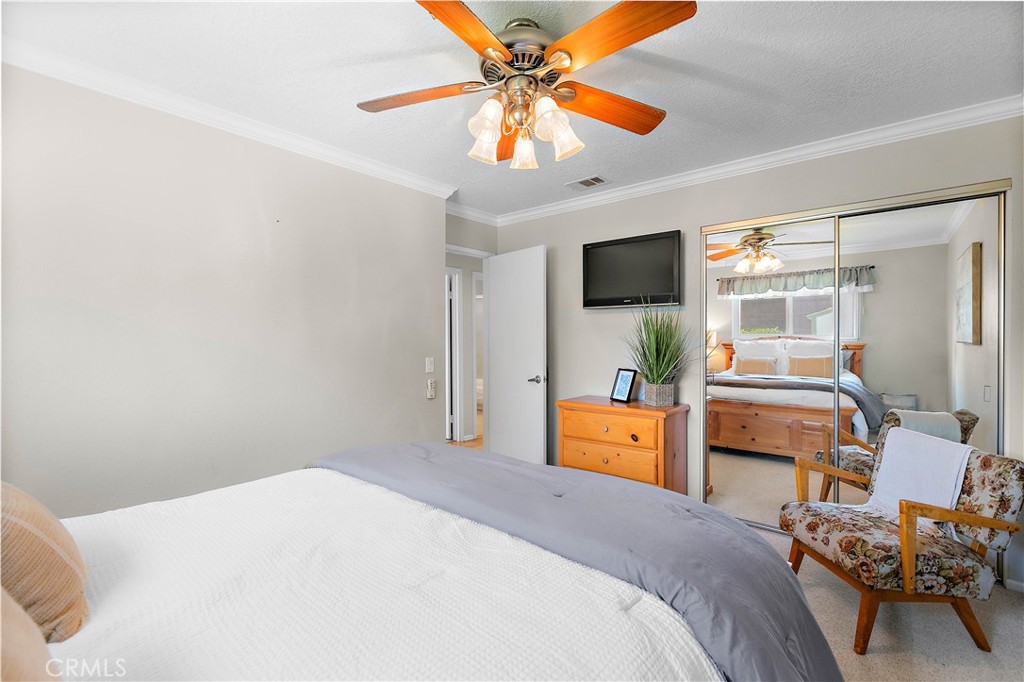 7241 Marine Avenue Rancho Cucamonga, CA 91701 - Photo 26 of 48 a bedroom with a bed and a chandelier fan