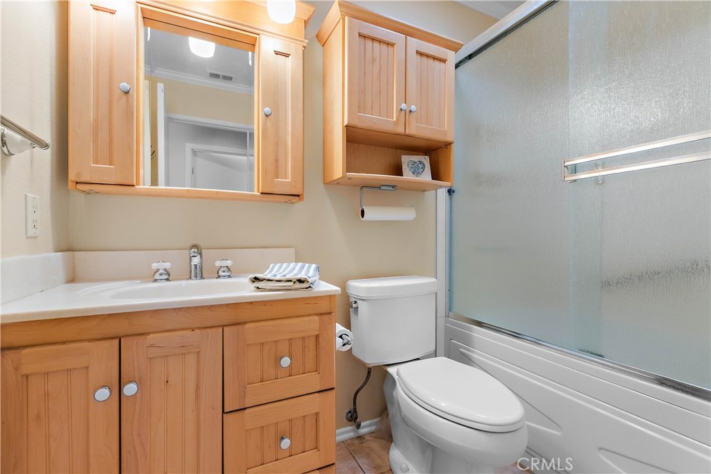 7241 Marine Avenue Rancho Cucamonga, CA 91701 - Photo 27 of 48 a bathroom with a granite countertop toilet sink and mirror