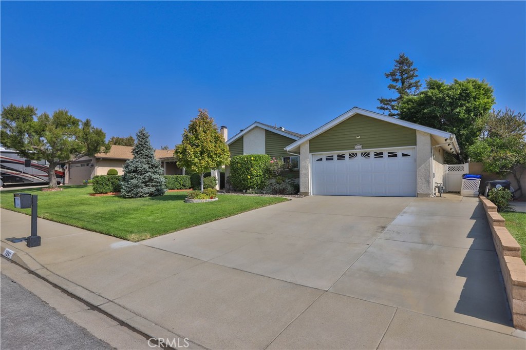 7241 Marine Avenue Rancho Cucamonga, CA 91701 - Photo 3 of 48 a front view of a house with a yard and garage